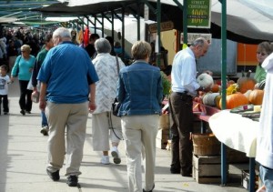 Shoppers crowd an urban Farmer's Market.